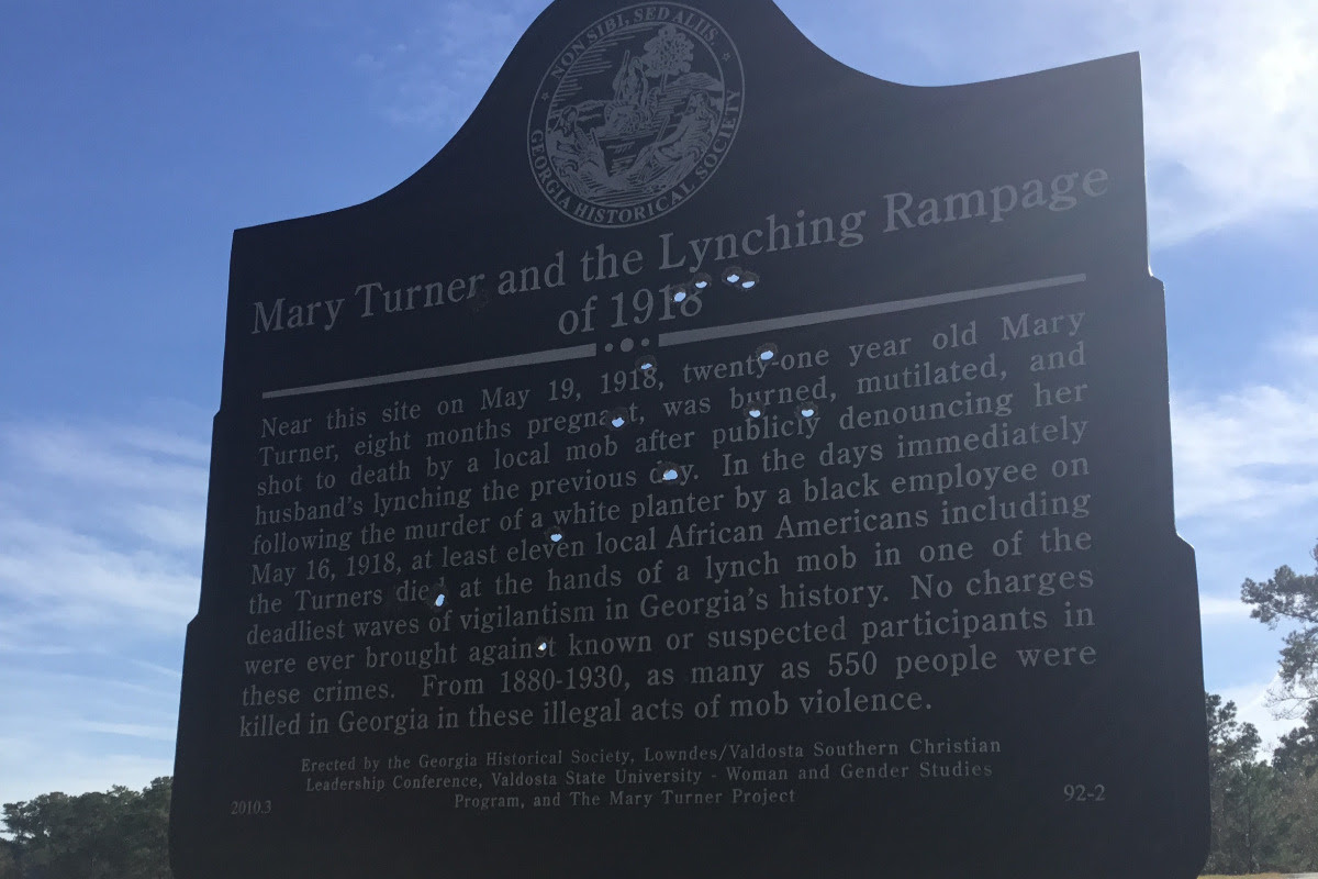 A recent photo shows the original historical marker for Mary Turner and the Lynching Rampage of 1918 had been shot through several times. (Photo courtesy of the Mary Turner Project.)